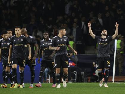 Qarabag’s players celebrate their side’s second goal scored by Qarabag’s Marko Jankovic (right) from the penalty spot during the Champions League opening phase football match against Chelsea in Baku, Azerbaijan, yesterday.