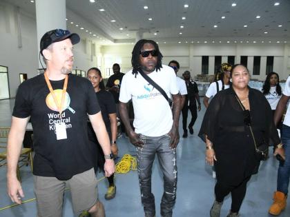 Dancehall artiste Vybz Kartel (centre) touring the World Central Kitchen (WCK) worksite at the Montego Bay Convention Centre in St James with members of his team from the Adidja Palmer Foundation along with WCK response director, John Torpey (left), on Nov