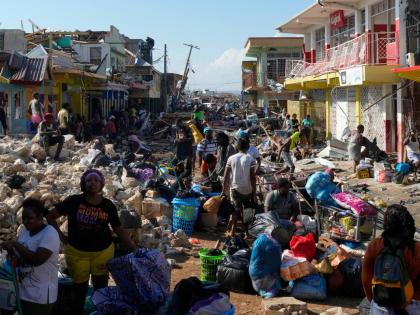 Residents gather amid debris in the aftermath of Hurricane Melissa on a street in Black River, Jamaica, on October 30.