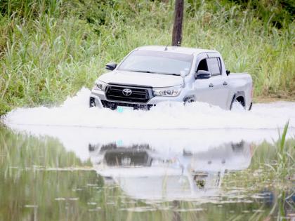 A driver crosses the flooded roadway in Content, Williamsfield, Manchester, where rising underground water has flooded several houses and the roadway making it impassable.