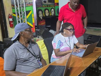 President of the Western Jamaica Media Association, Janet Silvera (centre) in conversation with her vice president, Garwin Davis (right) and veteran journalist Adrian Frater while at work at the newly installed media centre at S Hotel Montego Bay. 