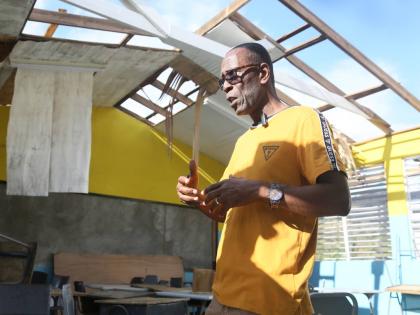 
Reverend Winston Pecco, chairman of Edwin Allen High School in Clarendon, explaining the extent of the damage caused by Hurricane Melissa at the institution.
