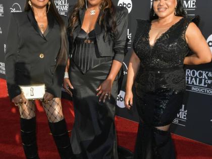 From left: Jamaican-American rapper Sandra Denton, DJ Spinderella and Cheryl James of Salt-N-Pepa in bold black ensembles — blending tailoring, satin and sequins for their Rock & Roll Hall of Fame moment.