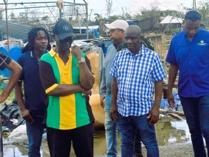 Minister of Local Government, Desmond McKenzie (2nd left) and Mayor of Falmouth, Collen Gager (right front) tour the town of Falmouth with other technocrats in the government and vendors displaced by Hurricane Melissa.