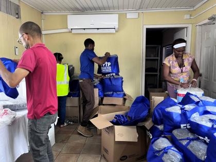 Food For The Poor Jamaica team members arrange packages and emergency supplies to assist those affected by Hurricane Melissa.