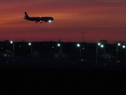 An airplane prepares to land at O'Hare International Airport, in Chicago, Wednesday, November 12, 2025. (AP Photo/Nam Y. Huh)