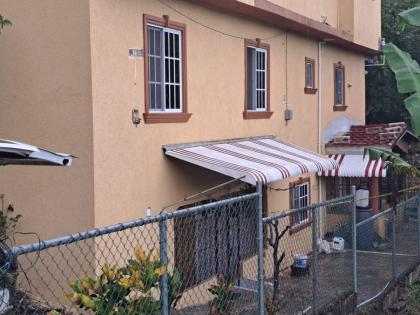 The home of school teacher Tara Pinnock and her daughter Talia Wright in Mount View Estate in Spanish Town, St Catherine, where their bodies were found with stab wounds and their throats slashed on Thursday, November 13, 2025.