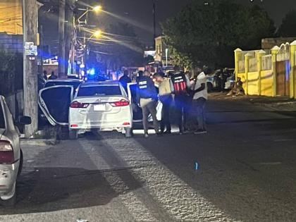 Police personnel at the crime scene along Waltham Park Avenue in St Andrew, in the vicinity of 83 Lane, where two off-duty cops were shot dead last night.
