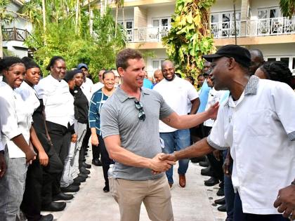 Executive Chairman of Sandals Resorts, Adam Stewart (centre), interacts with team members during his visit to the resorts following the passage of Hurricane Melissa.