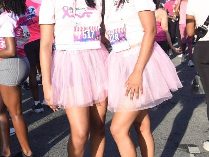 Below: Shantell Dixon (left), sales support officer at Sagicor, and Toni Campbell, senior compliance manager at Scotiabank, step out in matching pink cowboy hats.