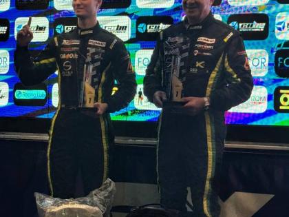 Senna Summerbell (left) and Christopher Issa accepting the winning trophy as the first Jamaicans drivers to win a European Drivers Championship.