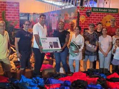 St James Southern Member of Parliament Nickeisha Burchell (fourth left) accepts a solar street light from Bhasker Reddy Sharu and members of the Montego Bay Indian community last Friday at the Heinz School in Montego Bay.