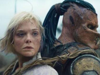 This image released by 20th Century Studios shows Thia portrayed by Elle Fanning (left) and Dek portrayed by Dimitrius Schuster-Koloamatangi in a scene from ‘Predator: Badlands’.
