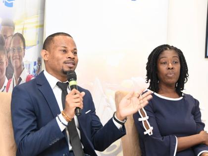 Devrhoid Davis (left) makes a point at the Smarter Credit Course workshop. Looking on is Dawnett Pryce-Thompson.