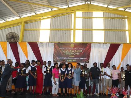 Awardees, parents, guardians and members of the Parent-Teachers’ Association pose with their awards during Dinthill High School’s ceremony at the Enos Barrett Multi-Purpose Hall.