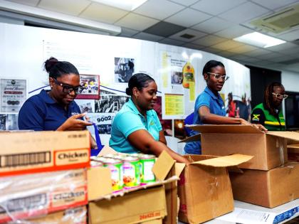 Campari staff prepare care packages for distribution to hard-hit parishes following the passage of Hurricane Melissa.