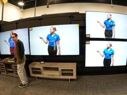 A customer turns away after looking at big-screen televisions on display in a Best Buy store, November 21, 2023, in southeast Denver.