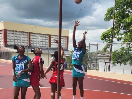 Denbigh High School goal shooter Chris Ana Wignall (right) shoots during an ISSA Rural Under-16 game against Glenmuir at Glenmuir yesterday.  Denbigh won 35-15. Looking on are from left: Denbigh goal attack, Arianna Agate, Glenmuir goal defence, Aniiya Har