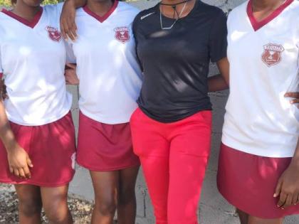 Photo by Raymond Graham
Kellits High school’s netball players Shanay (left), Sheamoy (second left), and Shenelle Stewart (right) pose with their coach, Alaine Rochester just after their ISSA Rural Under-16 match against Denbigh High School on Thursday. 