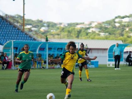 Left: Reggae Girlz’ Kalyssa Vanzantien gets ready to kick the ball during a Concacaf W qualification game against Dominica at the Daren Sammy Cricket Ground in St Lucia yesterday.