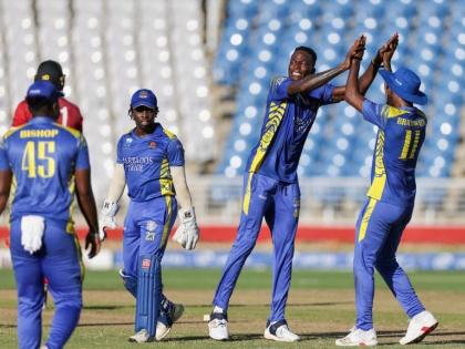 Photo by CWI Media 
Dominic Drakes (second right) celebrates one of his four wickets against the Trinidad and Tobago Red Force during the final of the CG United Super50 cricket competition at the Brian Lara Cricket Academy yesterday.