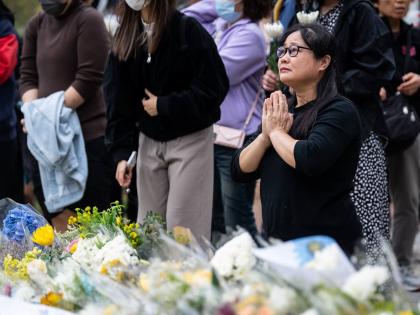 People offer flowers and pray for the victims near the site of a deadly fire at Wang Fuk Court, a residential estate in the Tai Po district of Hong Kong’s New Territories.