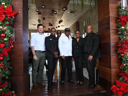 Tourism Minister Edmund Bartlett (centre) is flkanked by (from left) senior executives of the S Hotel Montego Bay, Radu Mot, Romie Morris, Ann-Marie Goffe-Pryce and Andres Cope. In the back is Christopher Jarrett, president of the Jamaica Hotel and Tourist