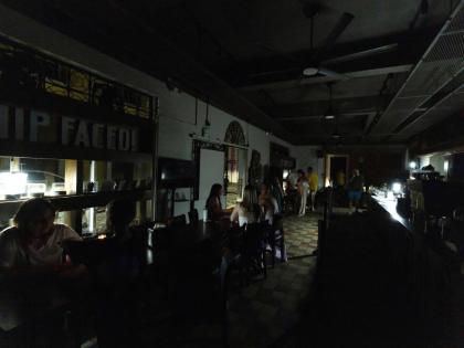 Customers sit inside a restaurant lit by battery-powered lanterns during an islandwide power outage, in Old San Juan, Puerto Rico, April 16, 2025. (AP Photo/Alejandro Granadillo, File)