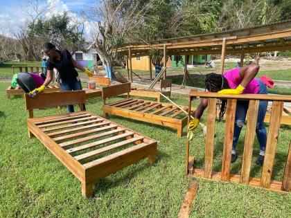 Volunteers cleaning bed-bases at the Mustard Seed Children’s Home in Adelphi, St James, following the passage of Hurricane Melissa on October 28.