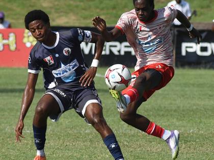 Mona High School’s Savi-k Morton (right) controls a ball ahead of Jamaica College’s Dontae Logan during their ISSA/WATA Manning Cup round-of-16 football match at the Stadium East field yesterday. The game ended 2-2.