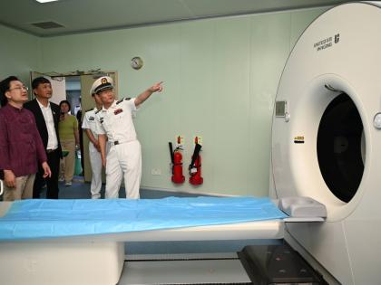 From left: Ambassador of the People’s Republic of China to Jamaica, Wang Jinfeng; Ziping Chen, chairman of the Fujian Association of Jamaica; and Li Min, crew member of ‘Ark Silk Road’ medical ship viewing a CT scan machine during a tour of the vesse