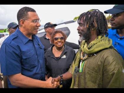 Prime Minister Dr Andrew Holness (left) shakes hands with Chief of the Accompong Maroons in St Elizabeth, Richard Currie, during a visit to the community on November 30, 2025. Looking on is Olivia Grange, minister of culture, gender, entertainment and spor