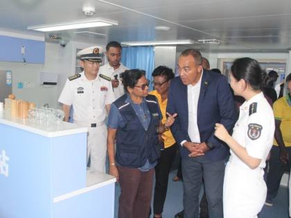 At left Dr Jacquiline Bisasor-McKenzie, chief medical officer, speaks with Dr Christopher Tufton (centre), minister of health and wellness, and crewmembers of the Ark Silk Road, a Chinese Navy hospital. 