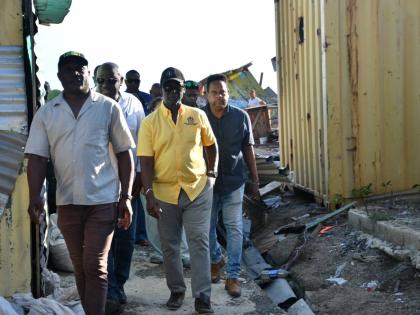 Minister of Local Government and Community Development Desmond McKenzie (second left) tours a section of the Savanna-La-Mar Market in Westmoreland last Wednesday to assess the damage caused by the recent passage of Hurricane Melissa. Joining him are (from 