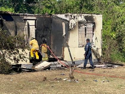 Firefighters at a house fire in Lime Tree Grove, St Catherine on December 6, 20205. The body of a man was found inside the dwelling. 