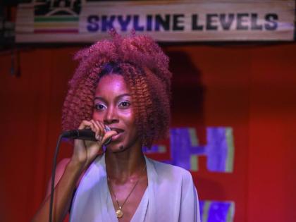 Artiste and songwriter Akina Eman steps out in a dramatic flounce top and velvet skirt.