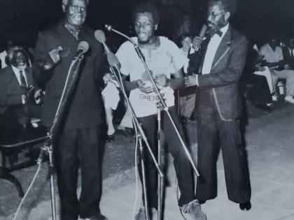 Jimmy Cliff in Zambia in 1982.  Pictured are: (from left) President Kenneth Kaunda of Zambia; Jimmy Cliff, and Mumba Kapumpa, Director of the Zambian Arts Council. Seated behind President Kaunda is Sam Nujoma, then leader of the SWAPO liberation movement a