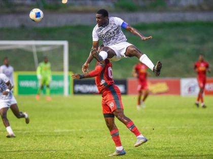 Cavalier skipper Jeovanni Laing (right) produces a towering header ahead of Mount Pleasant’s Brian Lee Brown during a Jamaica Premier League match at the Stadium East field yesterday.
