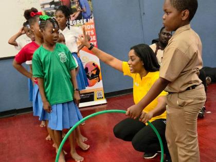 Dance Professor Renee Walters (second right) guides children through an activity at the GC Foster College’s inaugural Play for Recovery day at the school grounds yesterday.