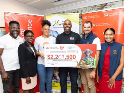 From left: Orette Duncan, client and partner services manager, GK General Insurance (GKGI); Marva Allen-Simms, board director, Jamaica Network of Rural Women Producers; poultry farmer, Shariann Brown, who recently received a symbolic cheque of $2.2m for th