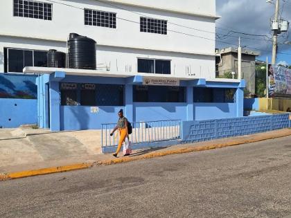 A woman walks past the Junction Public Sanitary Convenience that remains closed to the public after it was opened by Local Government Minister Desmond McKenzie in August. 