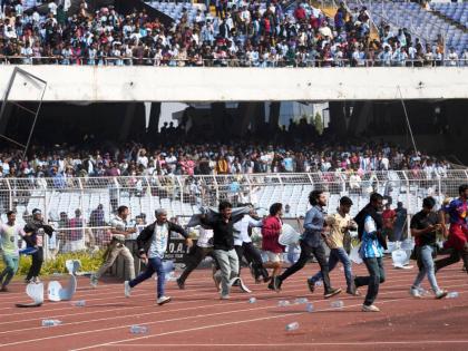 Indian fans vandalise stadium chairs as they run on to the field after failing to get a glimpse of Argentine soccer star Lionel Messi at the Salt Lake Stadium, in Kolkata, India, Saturday, December 13, 2025. (AP Photo/Bikas Das)