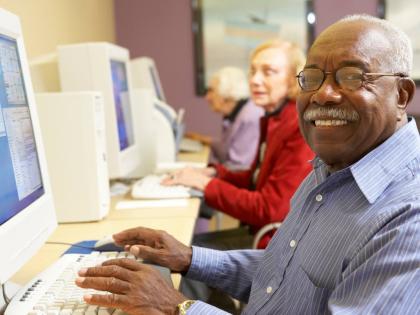 Representational image of an elderly gentleman working on a computer.