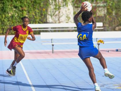 Wolmer’s Girls’ Schools’ Akayla Samuels (left) runs toward Mickayda Lyons of Jonathan Grant during the ISSA Urban Netball semi-finals at the Leila Robinson Courts, Kingston on Thursday.