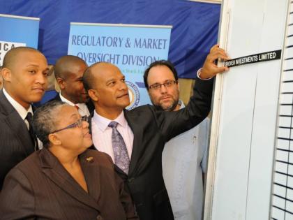File
Paul Simpson (left), founder of Cornerstone who was then a vice-president at Proven Wealth Ltd, beside Chairman and co-founder of Proven Management Peter Bunting, along with other executives, in 2011 at the listing of Proven on the Jamaica Stock Excha