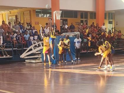 Holmwood Technical’s  goal shooter Syranna Brown (left) in action during yesterday’s senior all-island netball final at GC Foster College. 
