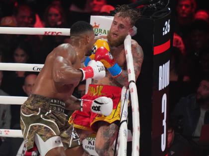 Anthony Joshua (left) in action against Jake Paul during their heavyweight boxing match on December 19, 2025, in Miami, Florida. 