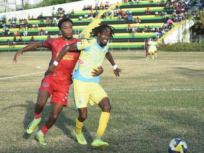 Waterhouse FC’s Omani Leacock (right) is challenged by Montego Bay United’s Richardo Ramsey during their Jamaica Premier League game at Jarrett Park yesterday.
