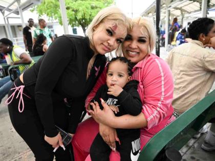 Alliah Moore (left) poses for a photo with her sister Amber Moore and nephew Aiden after the trio arrived on Monday.