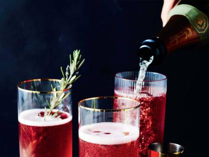 This image released by Voracious shows a recipe for a Champagne cocktail made with pomegranate juice, from the cookbook 'The Full Plate: Flavor-Filled, Easy Recipes for Families with No Time and a Lot to Do' by Ayesha Curry. 